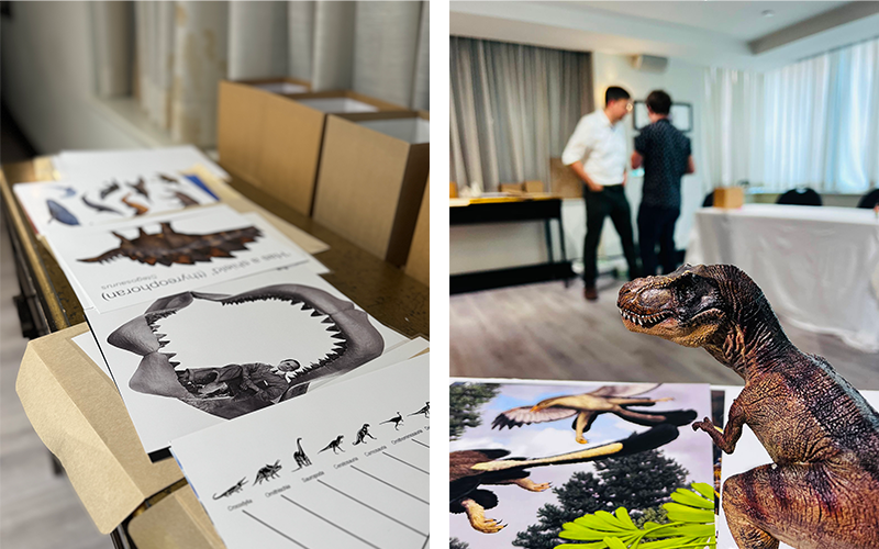Collage image of cue cards in front of boxes and two gentlemen speaking behind a T. rex figurine and more cue cards.